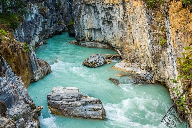 Explore 3 National Parks - Exclusive Small Group Tour - Natural Bridge and the force of the Kicking Horse River
