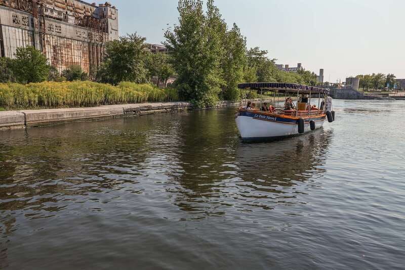 Montreal: Electric Boat Cruise with Onboard Drinks - Returning along Clock Tower Promenade